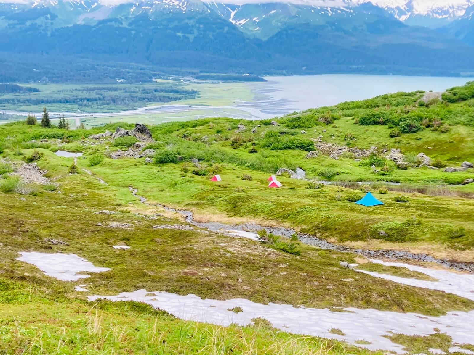 A mountain range with snow-capped peaks and clear skies